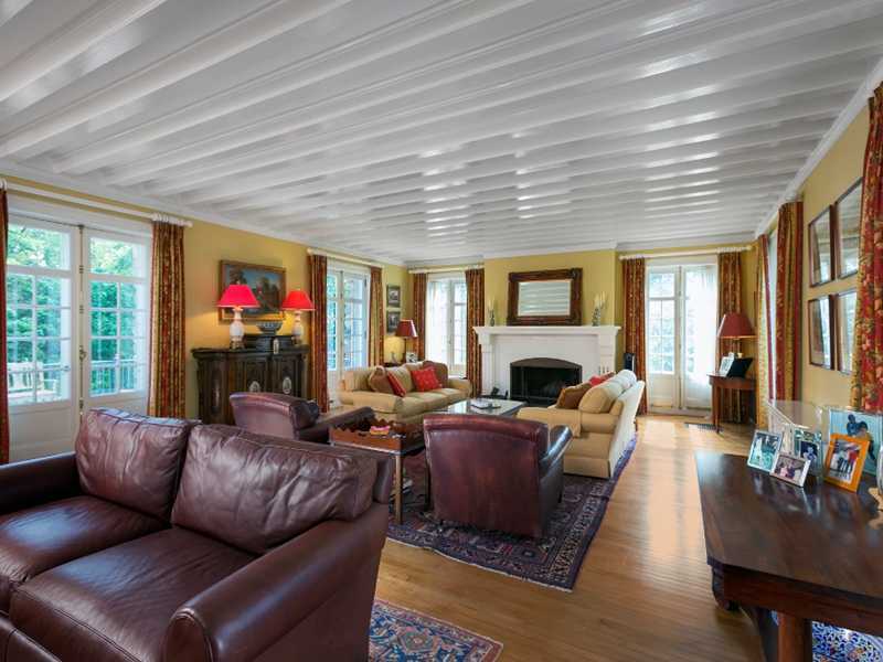 440 Middlesex Road Darien, CT 06820 - Photo 5 of 24 a living room with furniture a fireplace and a floor to ceiling window