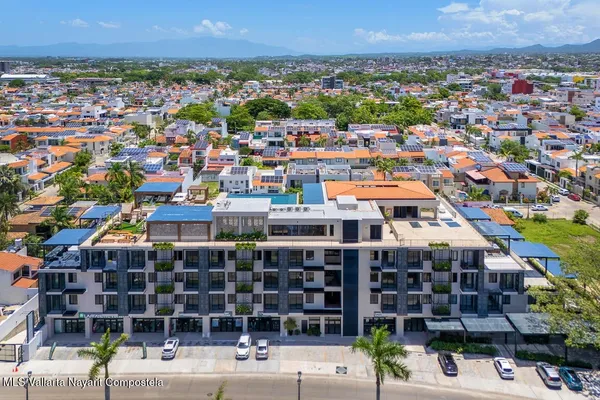 an aerial view of a house with a swimming pool outdoor seating and yard
