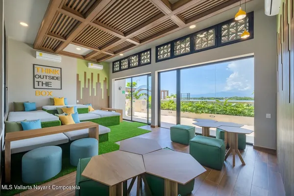 a bedroom with furniture and a large window