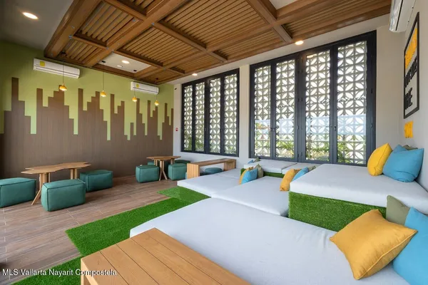 a patio with table and chairs and potted plants