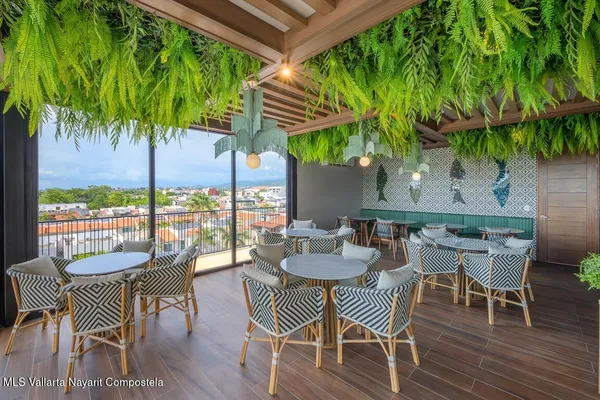 a view of a chairs and table in patio