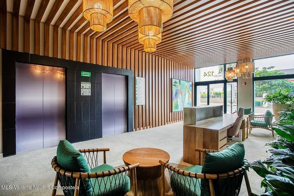 a living room with furniture and a painting on the wall
