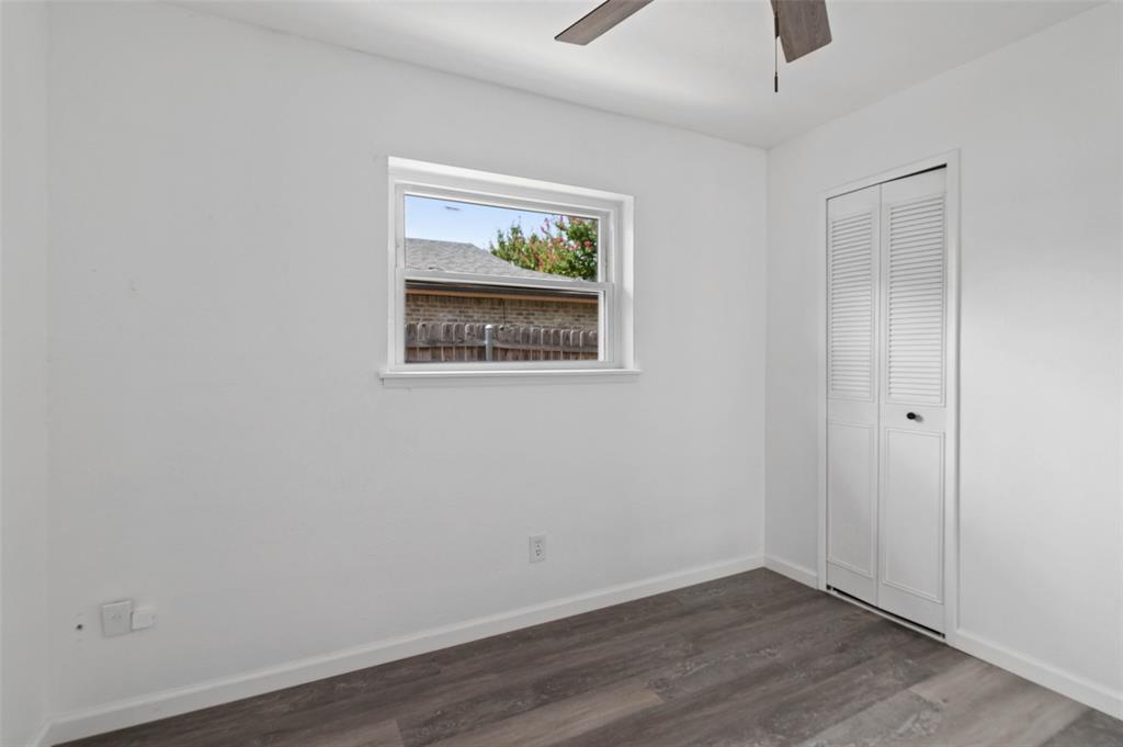 2068 East Peters Colony Road Carrollton, TX 75007 - Photo 19 of 24 an empty room with a window and wooden floor