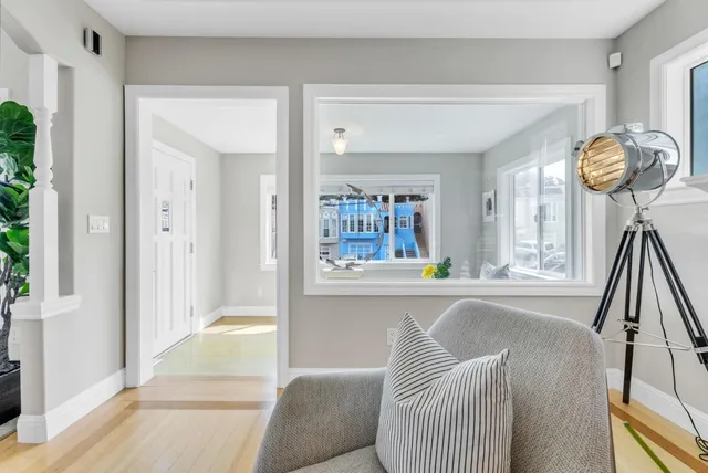 a dining room with furniture a chandelier and wooden floor