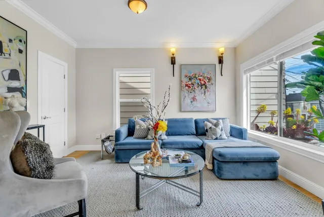 a view of a dining room with furniture and a chandelier