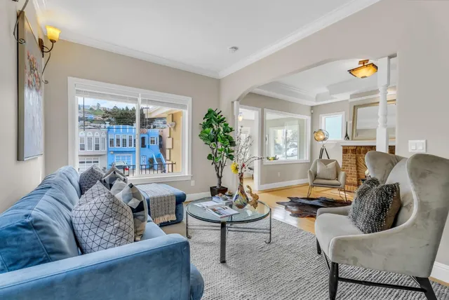 a dining room filled a chandelier a glass table and chairs