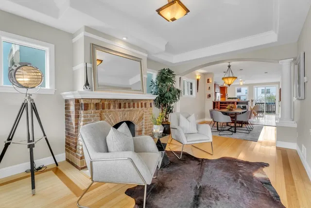 a living room with furniture or wooden floor and a potted plant