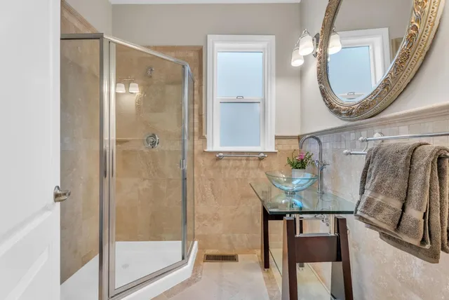 a living room with furniture a wooden floor and a large window