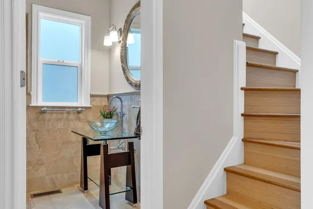 a bedroom with a bed and a potted plant