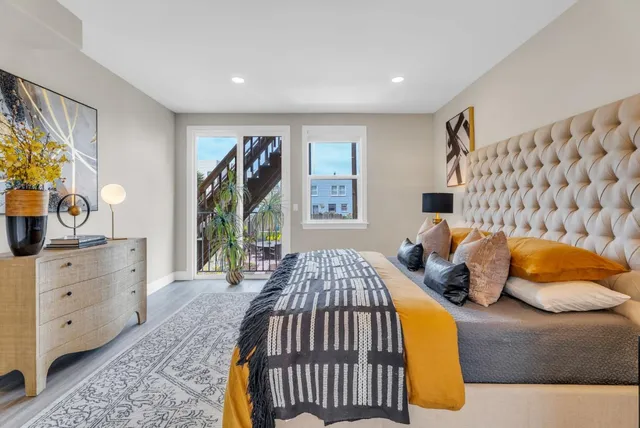 a bedroom with a bed and a chandelier