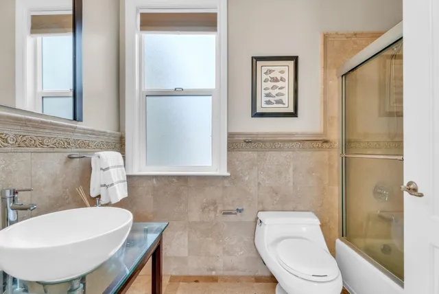 a view of a balcony with chairs and wooden floor