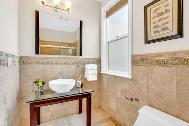 a view of a chairs and table on the terrace with a lake view