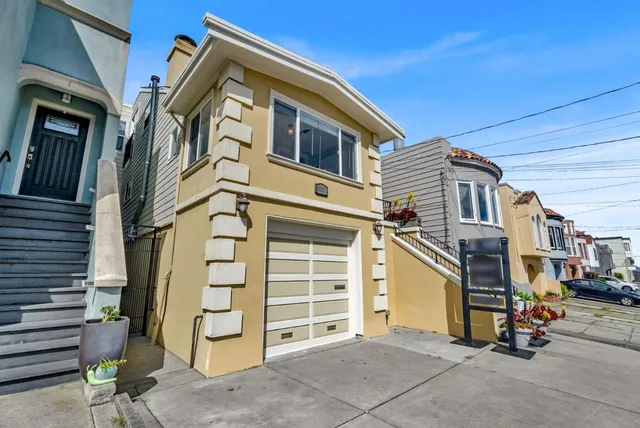 a living room with furniture and a painting on the wall