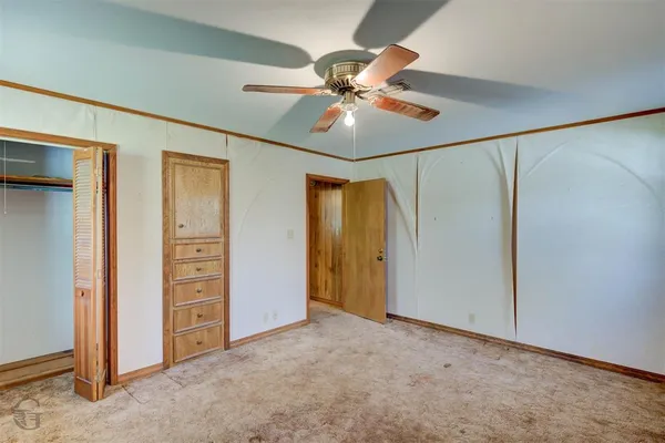 a view of a livingroom with a chandelier fan