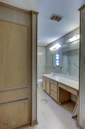 a bathroom with a double vanity sink and a mirror