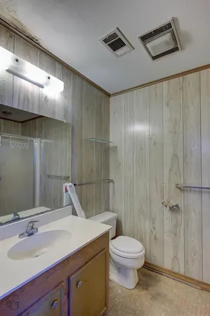 a bathroom with a toilet sink and shower