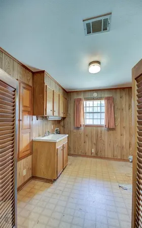 a view of a kitchen with a sink and cabinets