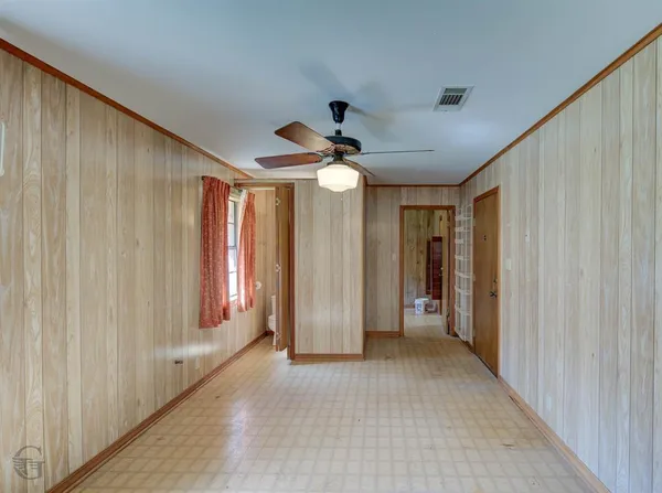 a view of hallway with window and a ceiling fan