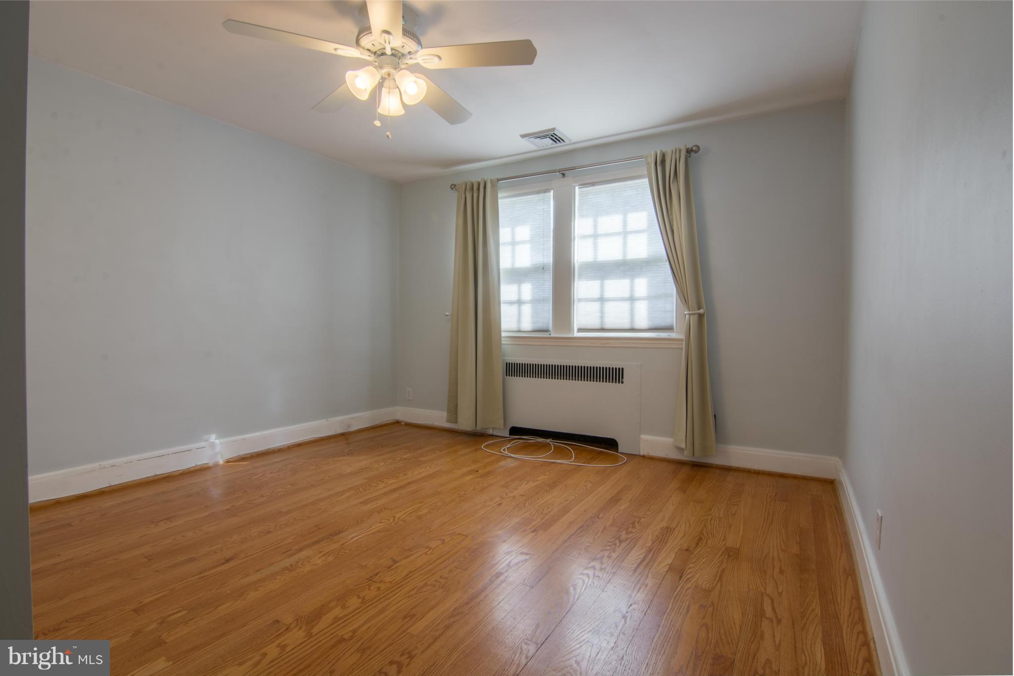 74 Murdock Road Baltimore, MD 21212 - Photo 15 of 30 an empty room with wooden floor fan and windows