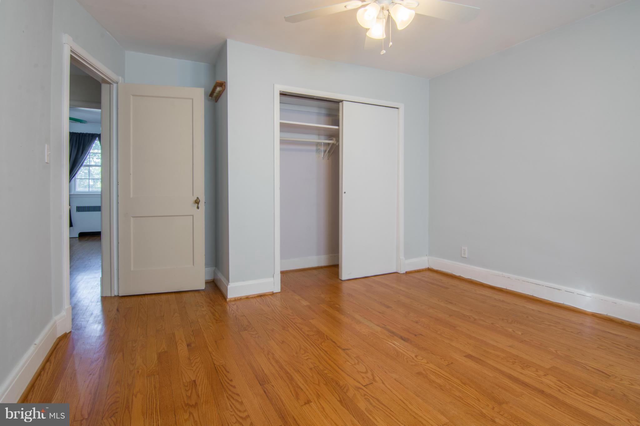 74 Murdock Road Baltimore, MD 21212 - Photo 17 of 30 a view of an empty room with wooden floor and a ceiling fan