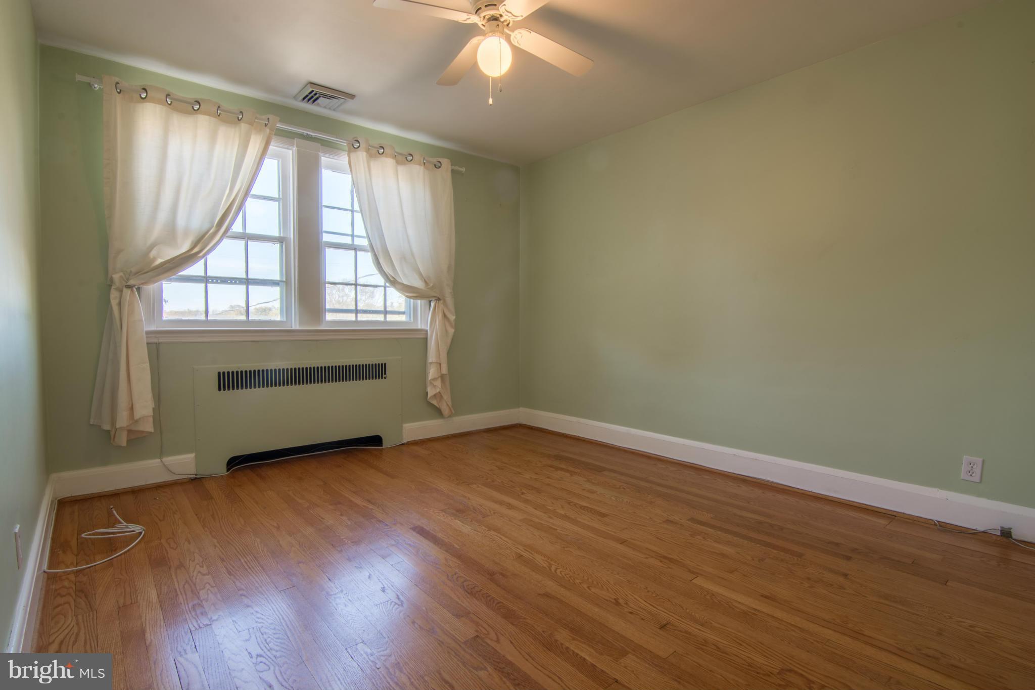 74 Murdock Road Baltimore, MD 21212 - Photo 18 of 30 an empty room with wooden floor and windows