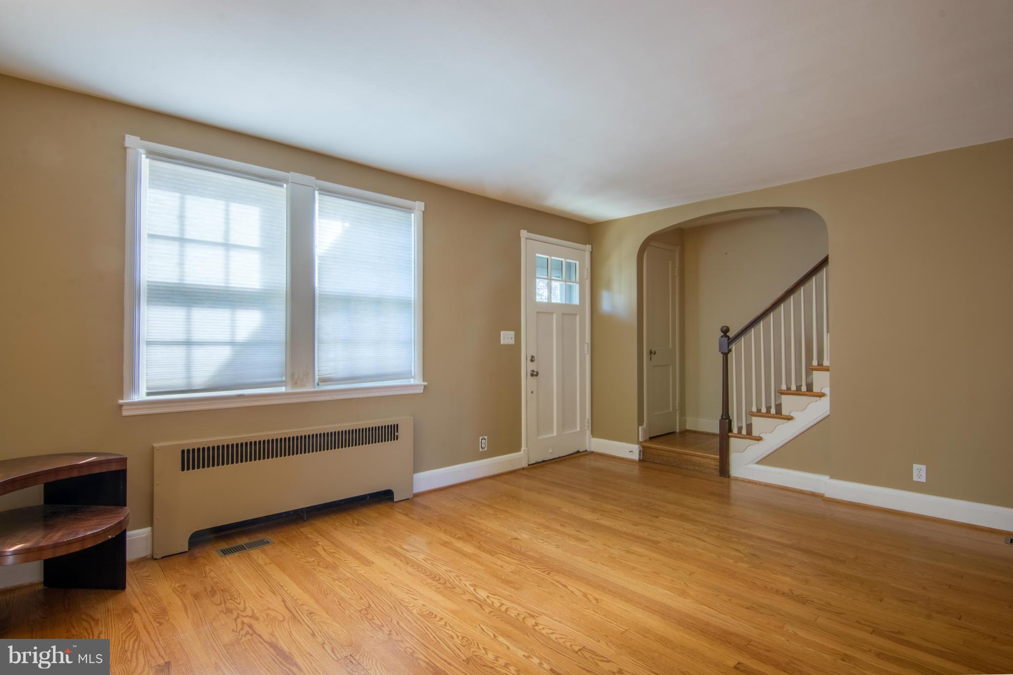 74 Murdock Road Baltimore, MD 21212 - Photo 5 of 30 a view of an empty room with a window and wooden floor