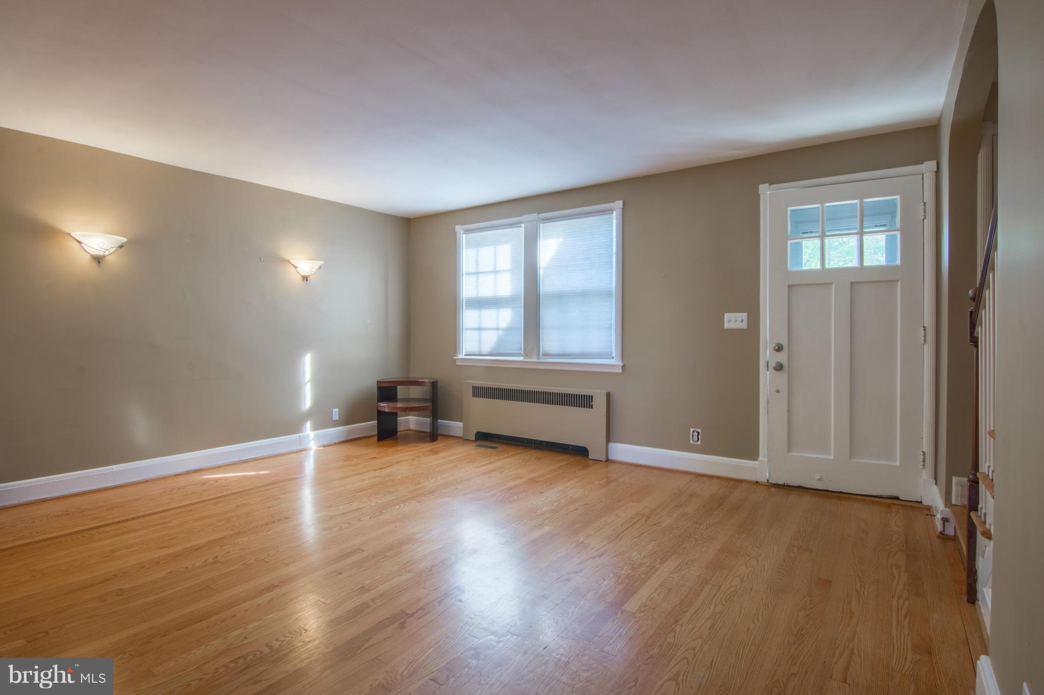 74 Murdock Road Baltimore, MD 21212 - Photo 6 of 30 an empty room with wooden floor and windows