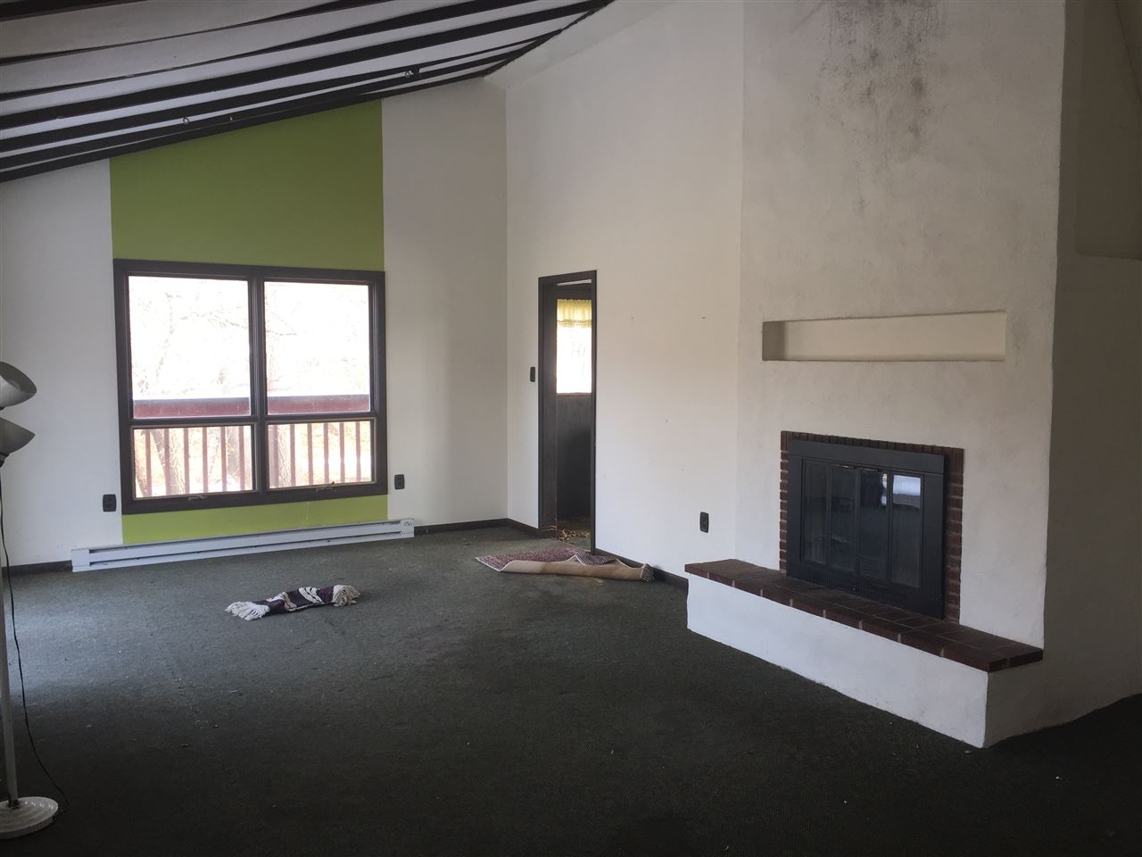 8775 Pomeroy Road Rockton, IL 61072 - Photo 4 of 12 a view of an empty room with a fireplace and a window