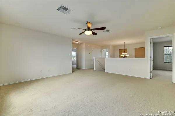 an empty room with a empty space and a ceiling fan