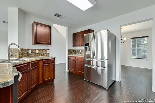 a kitchen with stainless steel appliances and wooden cabinets
