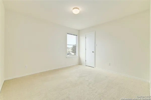 an empty room with windows and closet