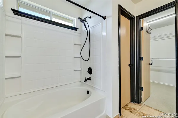 a bathroom with a glass shower door