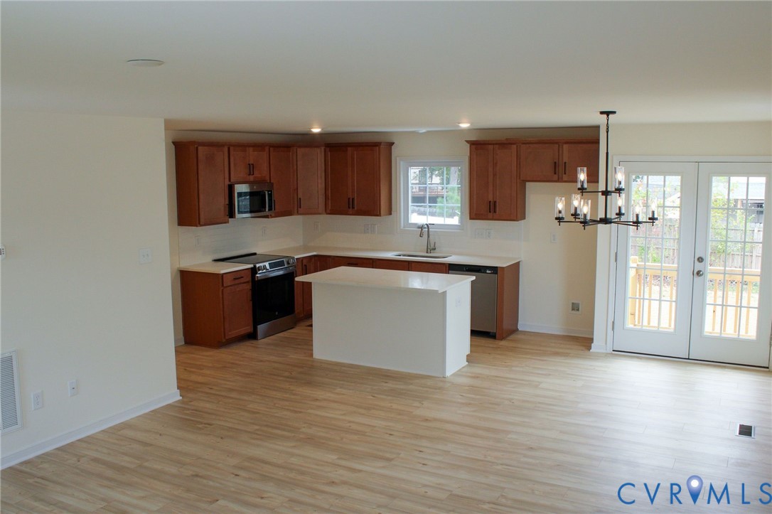 11632 Fort Cosby Drive Midlothian, VA 23112 - Photo 3 of 9 a kitchen with stainless steel appliances granite countertop a stove top oven a sink and a refrigerator