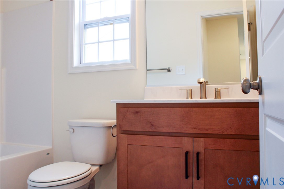11632 Fort Cosby Drive Midlothian, VA 23112 - Photo 8 of 9 a bathroom with a sink toilet and mirror
