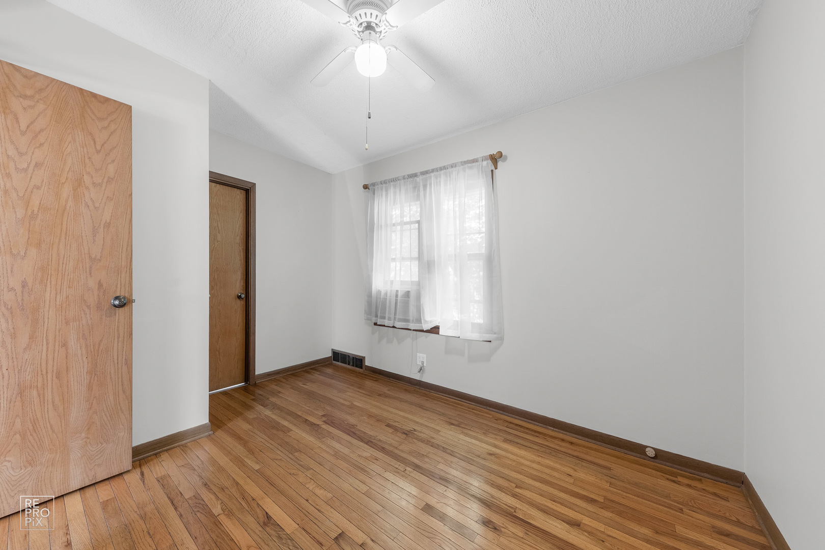 1382 Raymond Street South Elgin, IL 60177 - Photo 2 of 14 a view of an empty room with wooden floor and a window