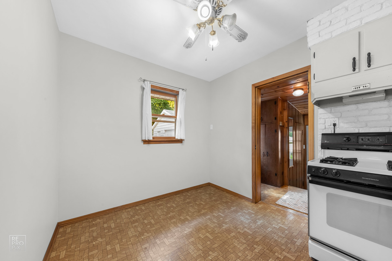1382 Raymond Street South Elgin, IL 60177 - Photo 7 of 14 a view of a kitchen with an empty space and a window