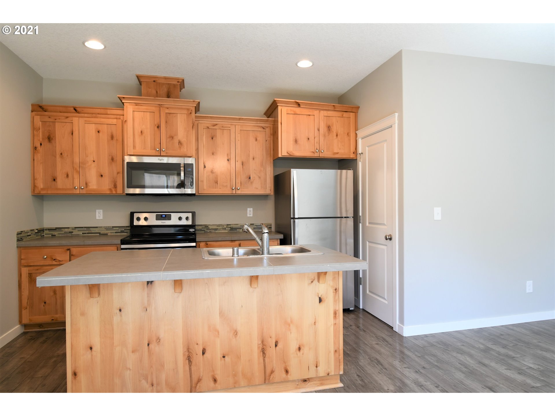 100 North 44th Place Ridgefield, WA 98642 - Photo 5 of 21 a kitchen with stainless steel appliances granite countertop a refrigerator a stove top oven a sink and dishwasher