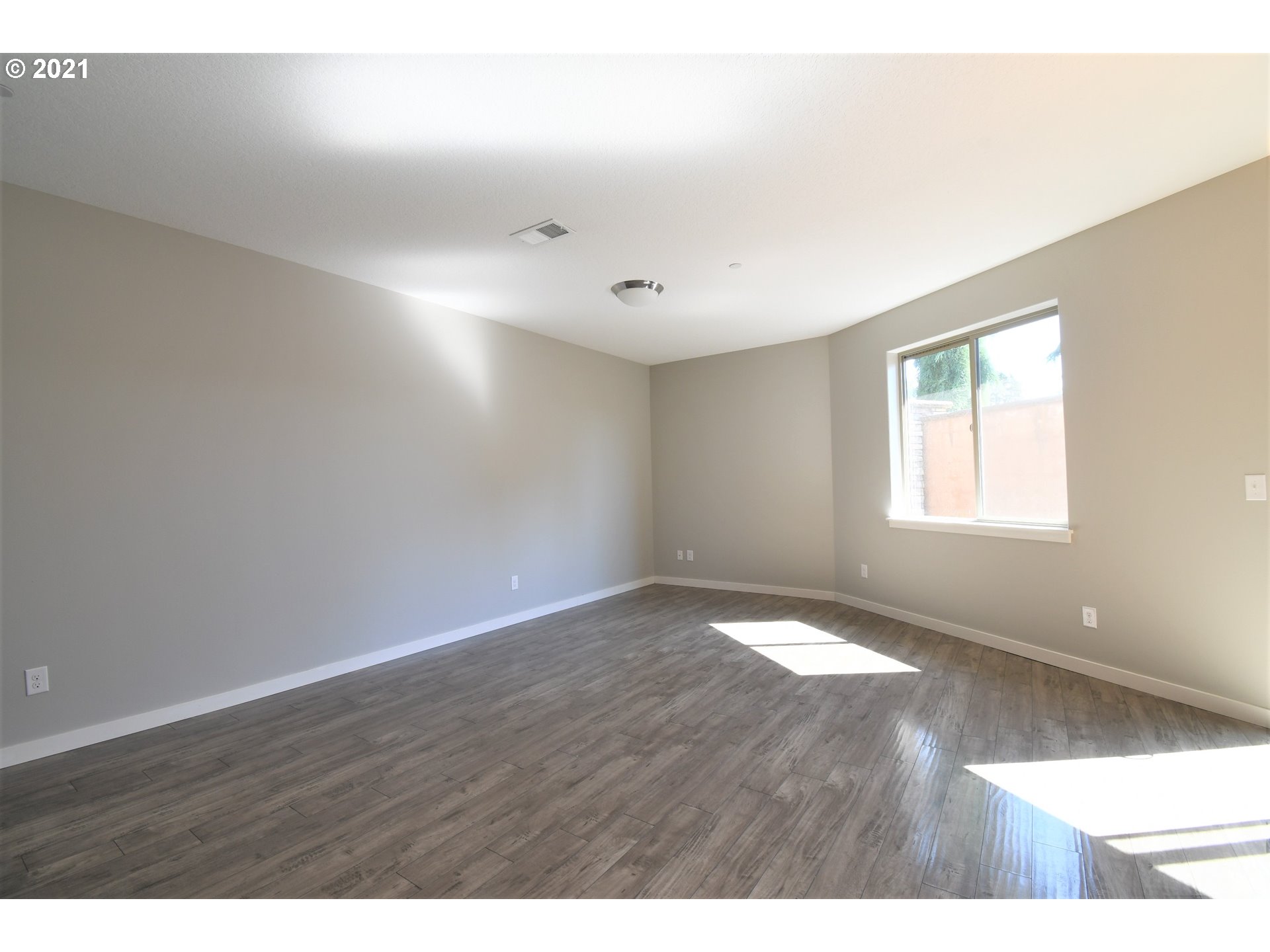100 North 44th Place Ridgefield, WA 98642 - Photo 8 of 21 a view of an empty room with wooden floor and a window
