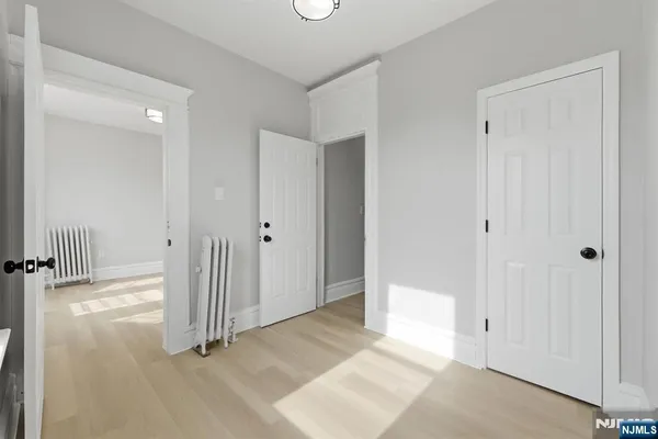 a view of a room with wooden floor and window