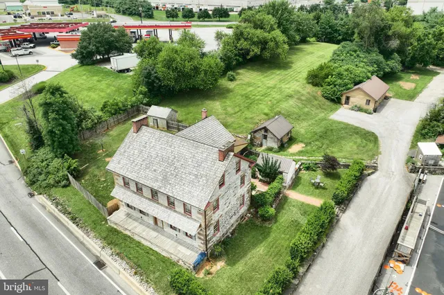 an aerial view of a house with a yard