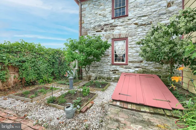 a view of a backyard with table and chairs and potted plants