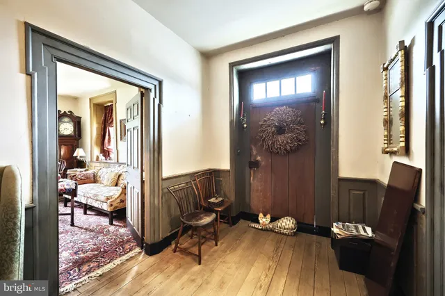 a view of a dining room with furniture a chandelier and wooden floor