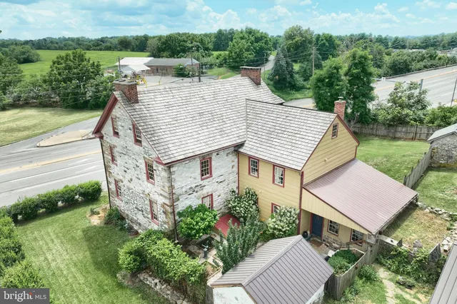 an aerial view of a house with a yard