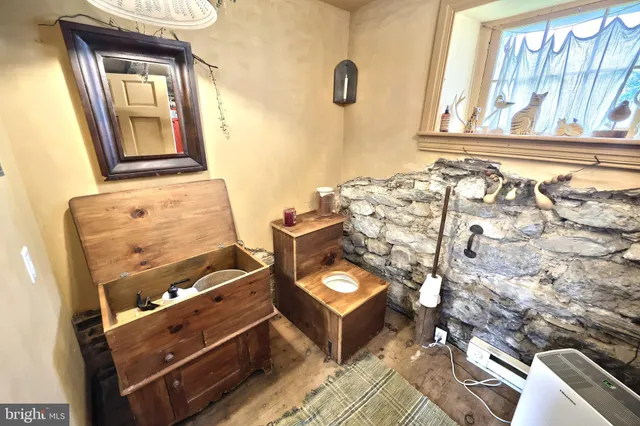 a view of a bedroom with furniture and a window