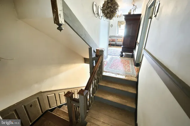 a living room with furniture and paintings on the wall