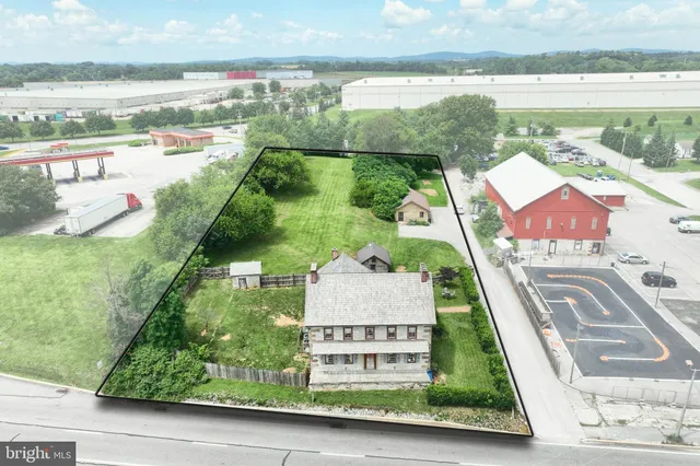 an aerial view of residential houses with outdoor space and swimming pool
