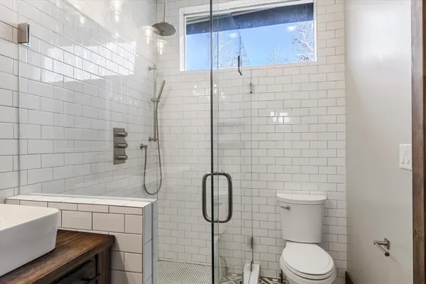 a bathroom with a sink toilet and a mirror