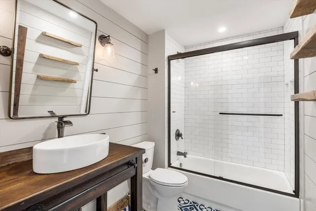 a bathroom with a sink toilet and shower
