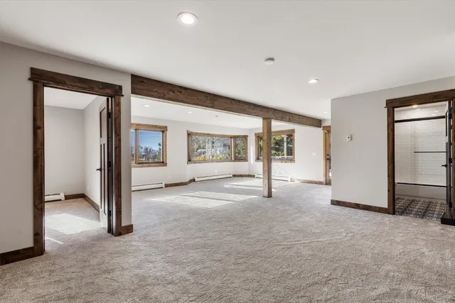 an empty room with sliding door and wooden floor