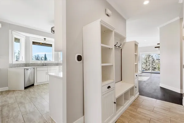a kitchen with granite countertop a sink a stove a microwave and wooden cabinets